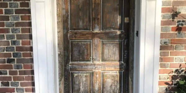 white frame with unpainted front door